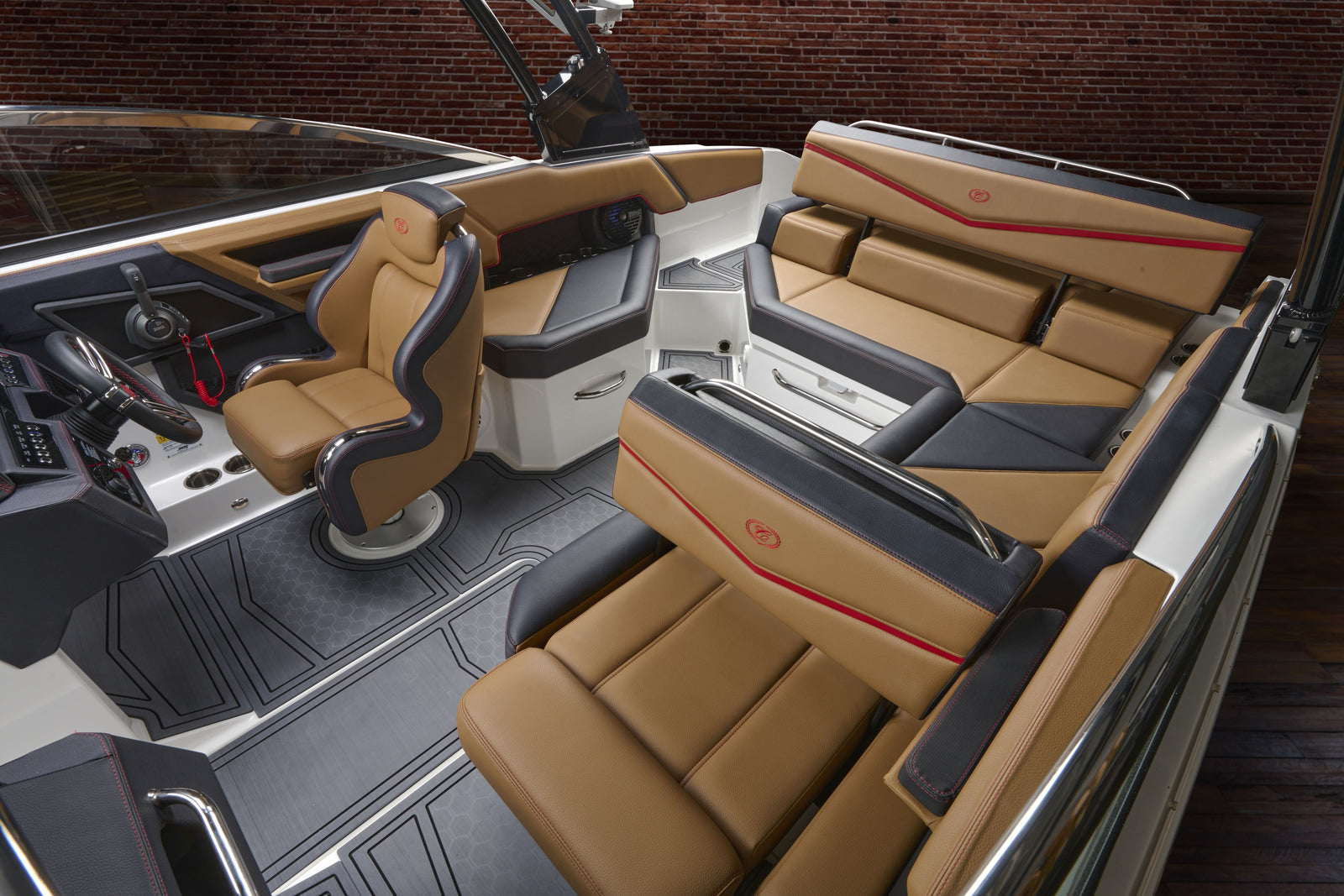 Interior of a boat with brown and black seats and dashboard.