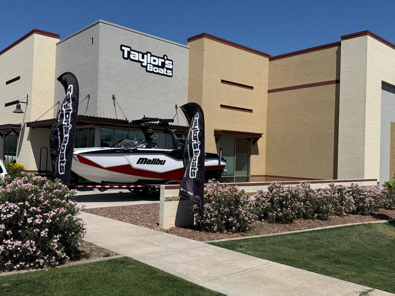 Malibu wakeboat on a trailer outside the Taylor's Boats dealership