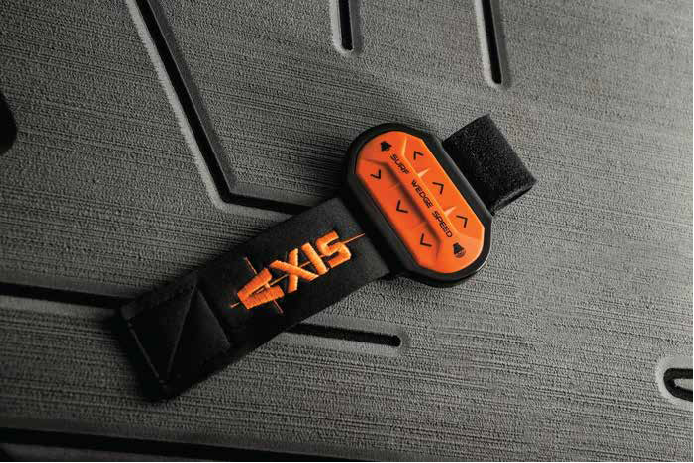 Orange and black Axis Surf Band wrist remote resting on a textured boat deck